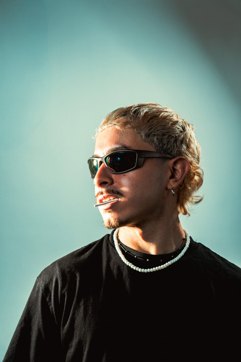 Sunglasses-wearing man with a cigarette, stylish fashion, modern accessories, trendy street style.