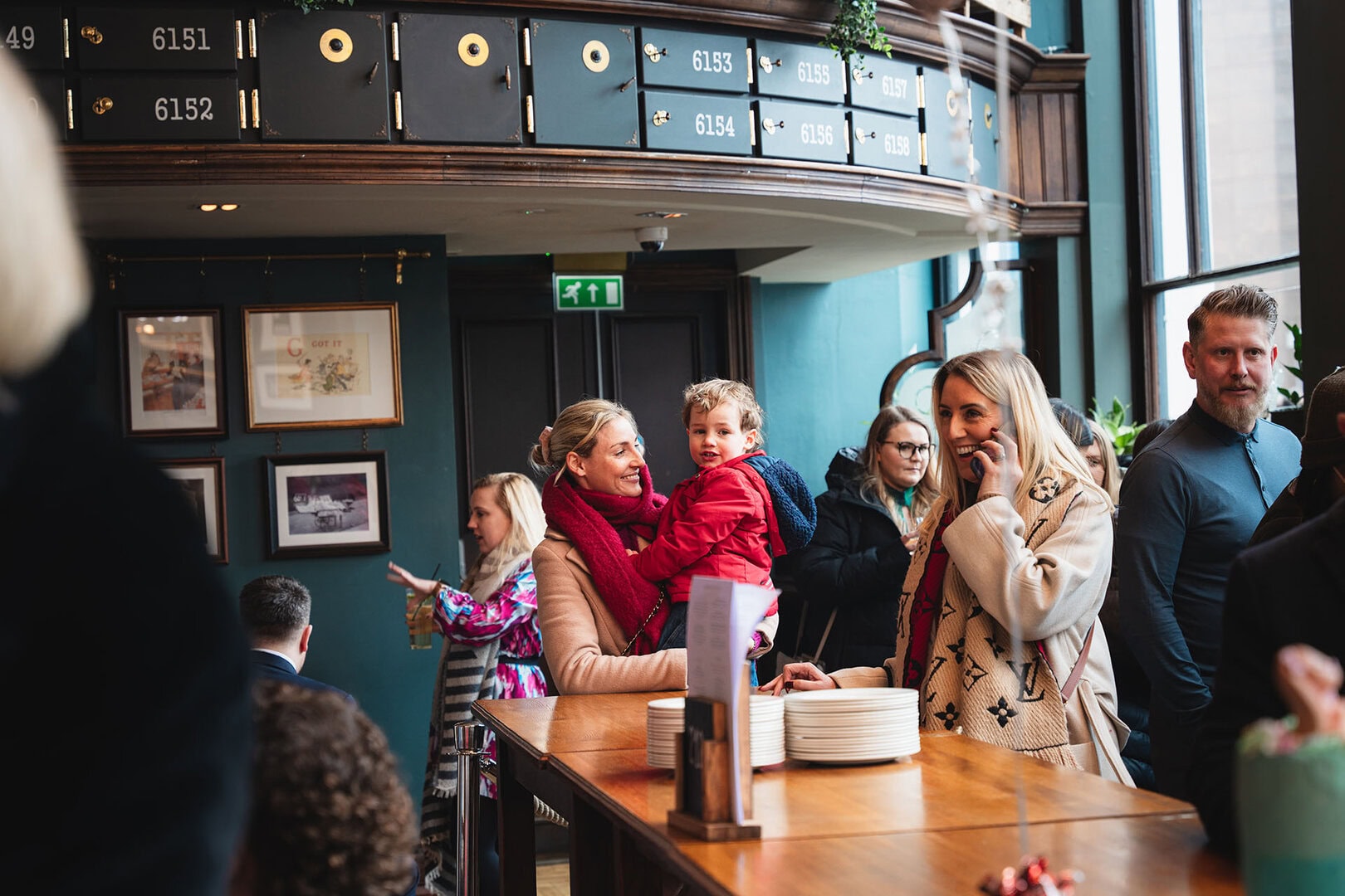 LemonLens shopping experience, lively café with families, diverse group, and modern interior design.