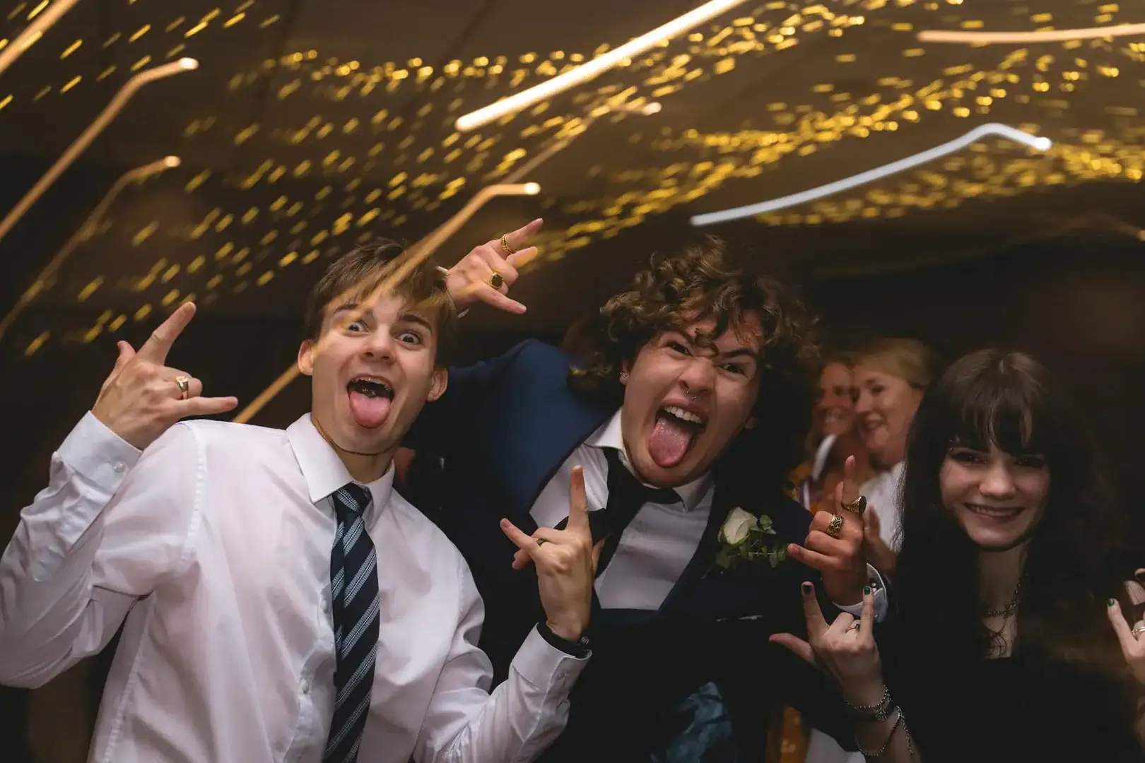 Vibrant party scene with young adults celebrating, colourful lights, and energetic atmosphere at a lively event.