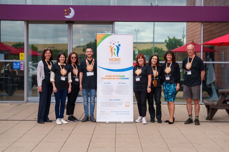 Hope, support, awareness, and community — diverse team members gather at a charity event, promoting inclusion, research, and education for rare developmental conditions.