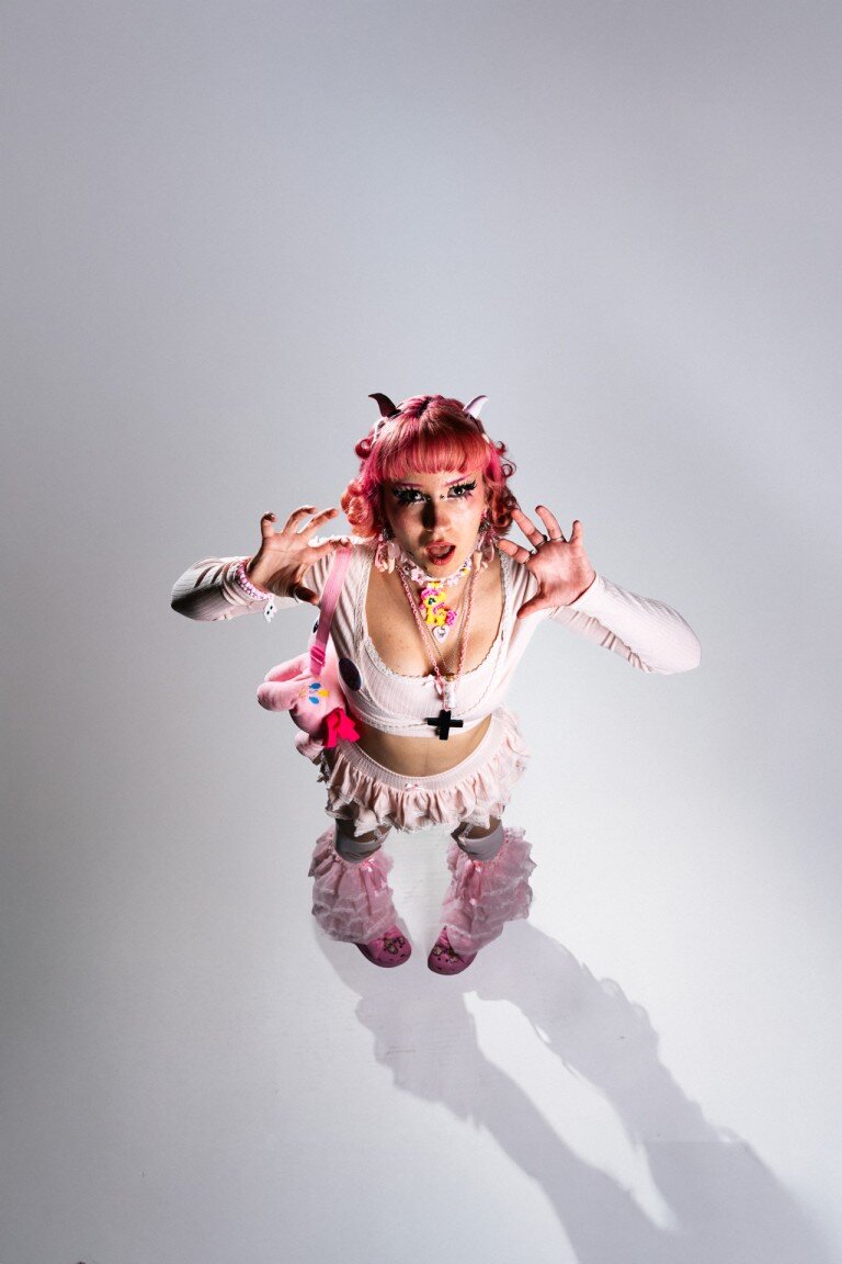 Vibrant kawaii object portrait of with curly pink hair, cosplay style, playful expression, colourful accessories, studio photography, fashion cosplay photography, high resolution.