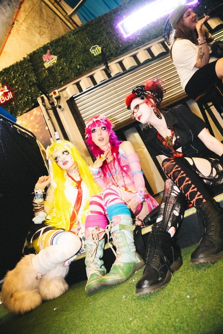 Vibrant group of people in colourful, alternative fashion at a London nightlife event, showcasing expressive portrait photography and nightlife photography.