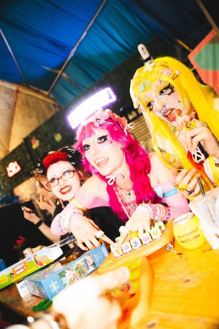 Vibrant cosplay party scene with colourful characters playing with toys at a themed event, showcasing creative costume photography and lively character portraits.