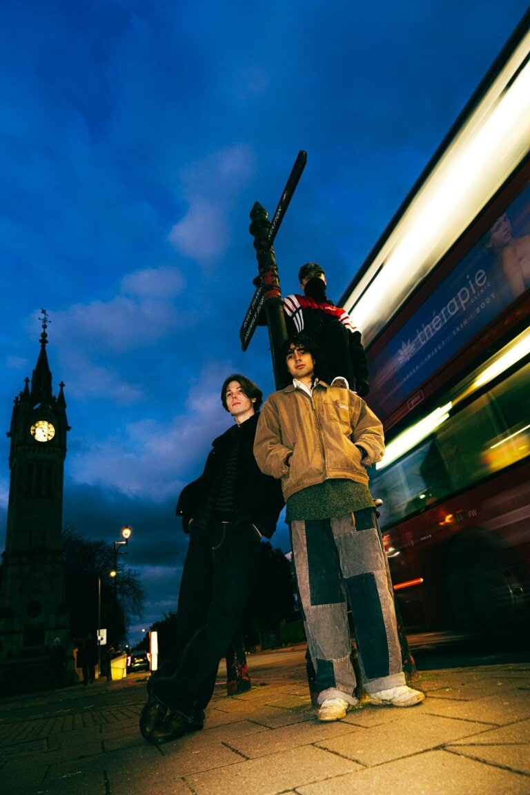 London street scene with three individuals by Big Ben clock tower during twilight, showing urban energy and city life.
