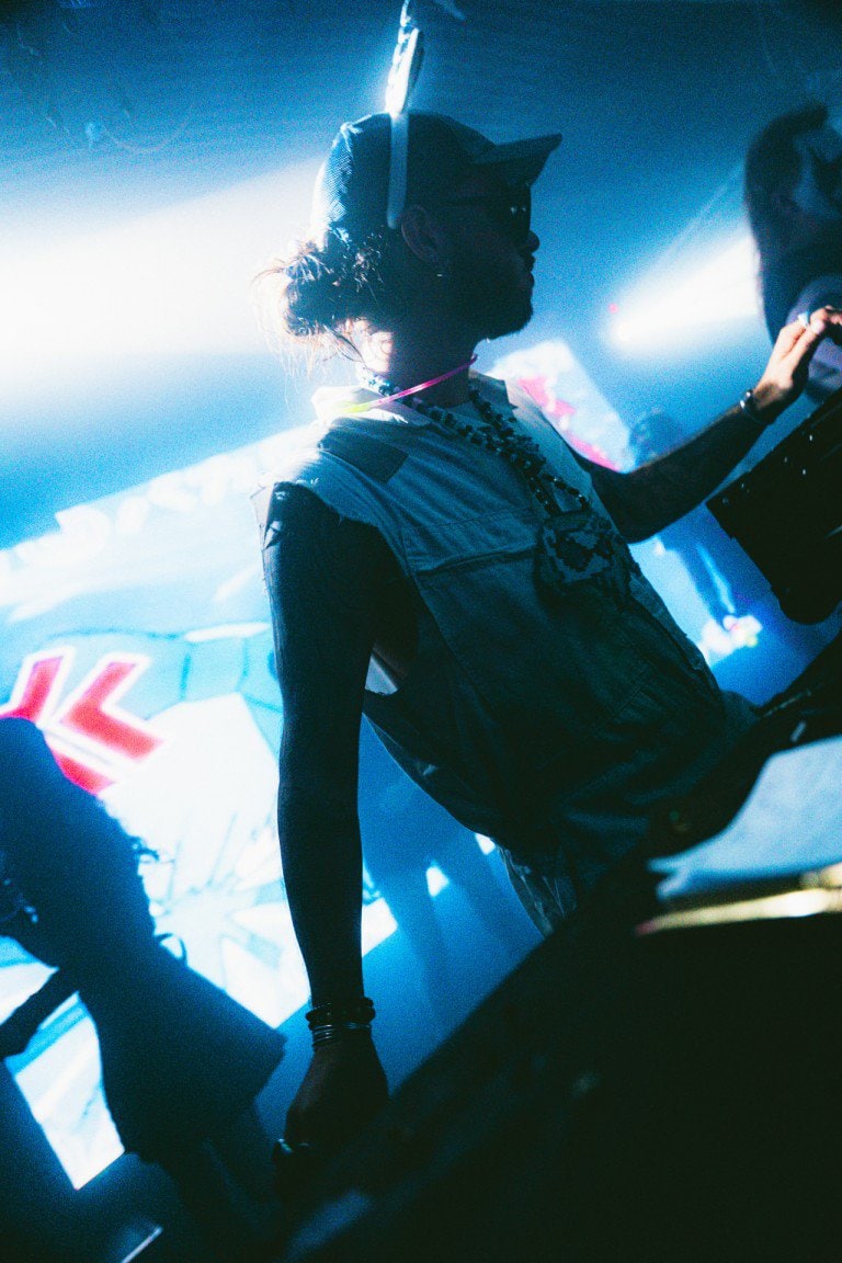 Vibrant nightclub DJ at a music event, capturing dynamic lighting and energetic atmosphere in a nightlife photography shot.