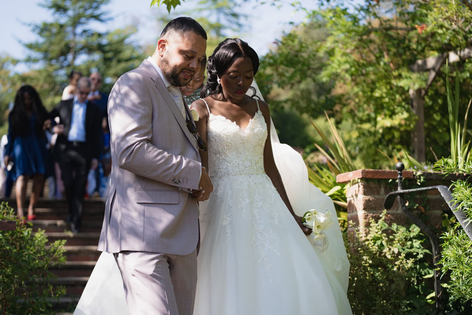 Beautiful wedding couple during outdoor ceremony captured in professional wedding photography at a garden venue.