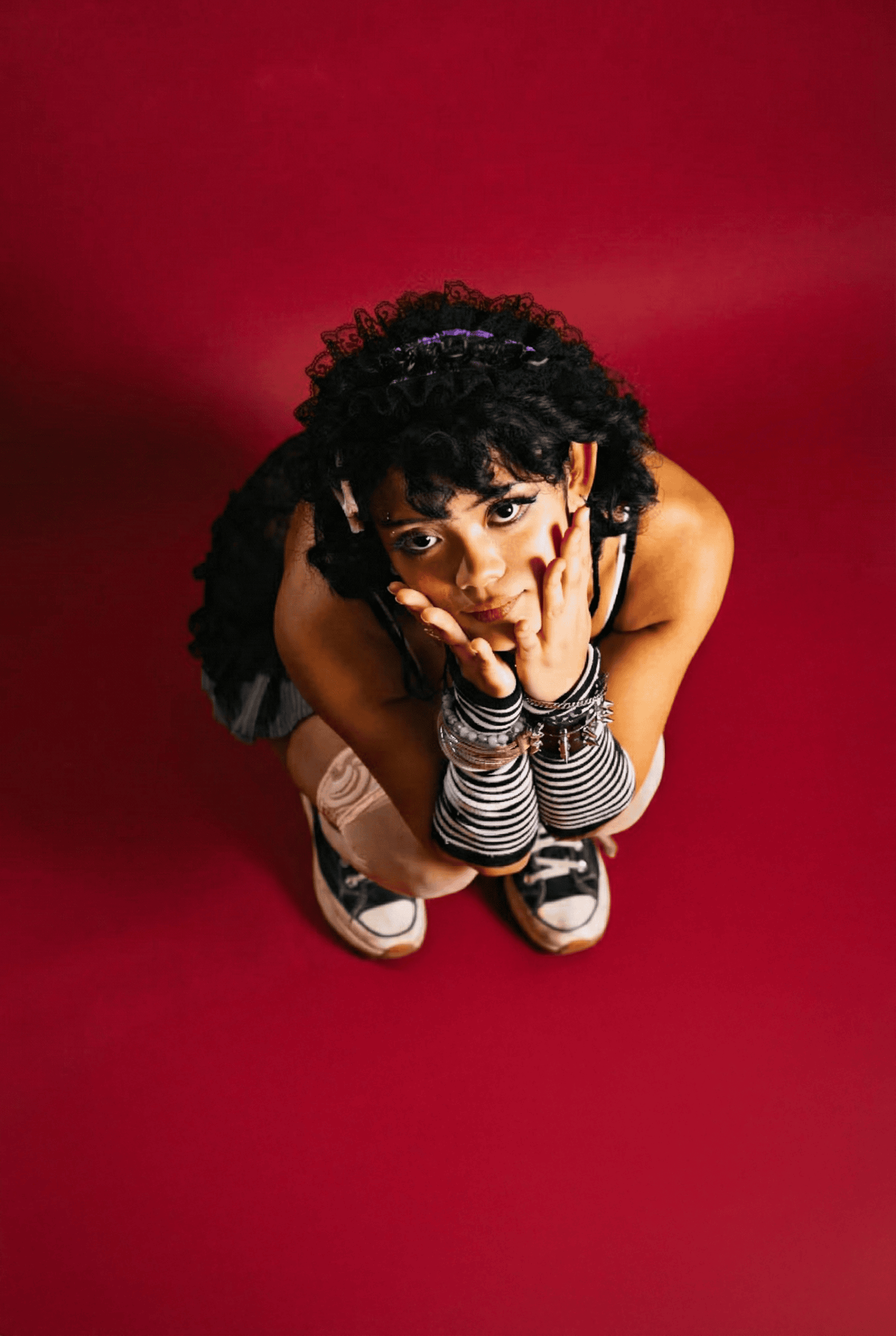 Vibrant red background studio session used for a Notting Hill brand piece