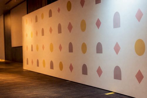 Empty step and repeat backdrop under soft lights