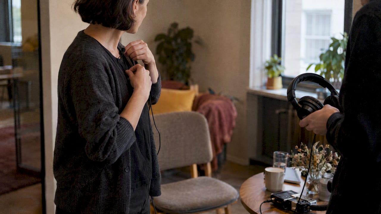 Contributor checking lavalier microphone placement