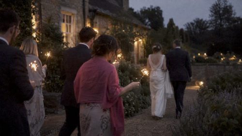 Wedding couple walking through sparklers