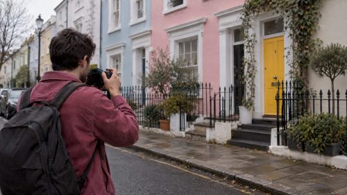 Photographer facing Notting Hill’s colourful houses