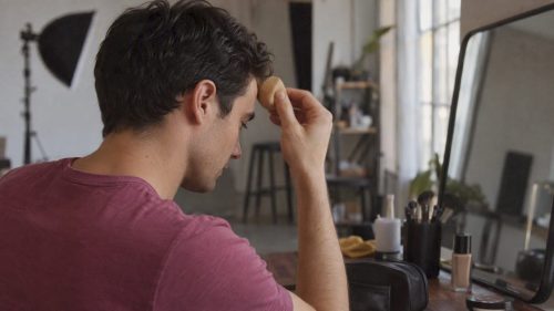 Actor applying makeup before a headshot