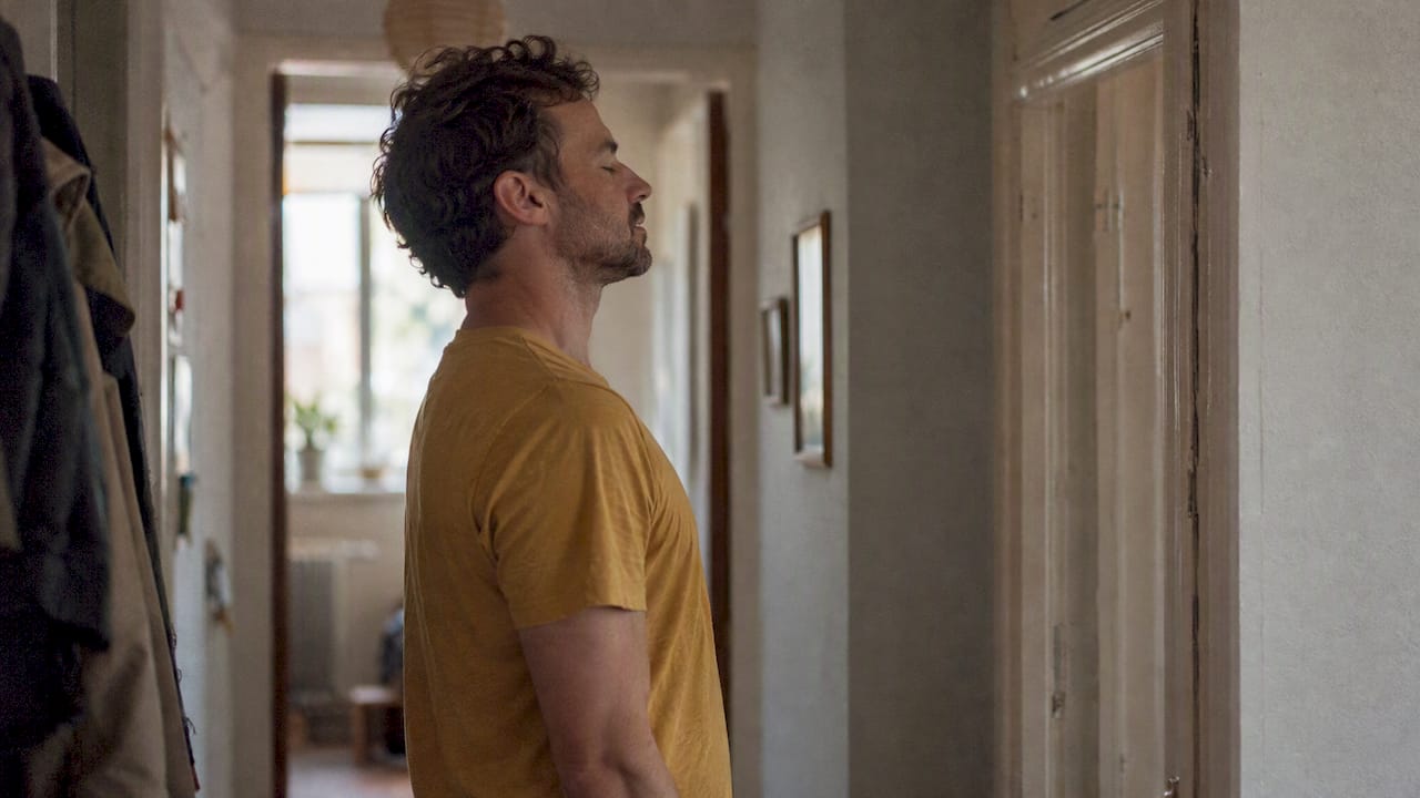 Man relaxing shoulders during a slow exhale